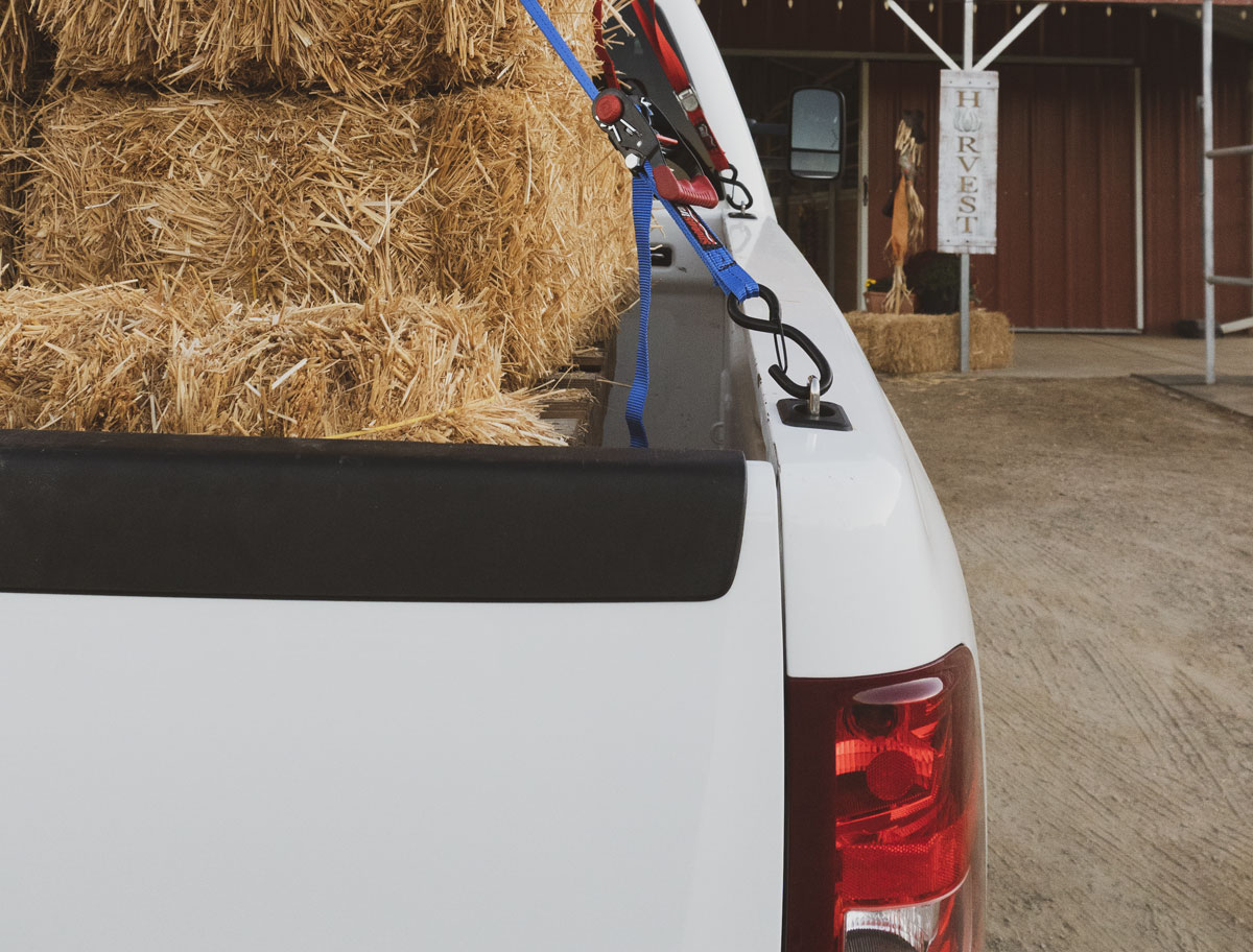 BullRing truck tie down anchors being used to strap down a hay bale