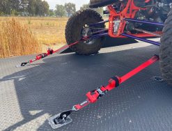 Red Ratchet Strap tie-down with a Tied down UTV on a trailer