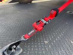Red Ratchet Strap tie-down with a tied down on a trailer