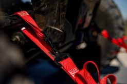 Red Ratchet Strap tie-down with a tied down on a trailer