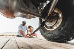 Tying down a vehicle to a trailer ahead of transport