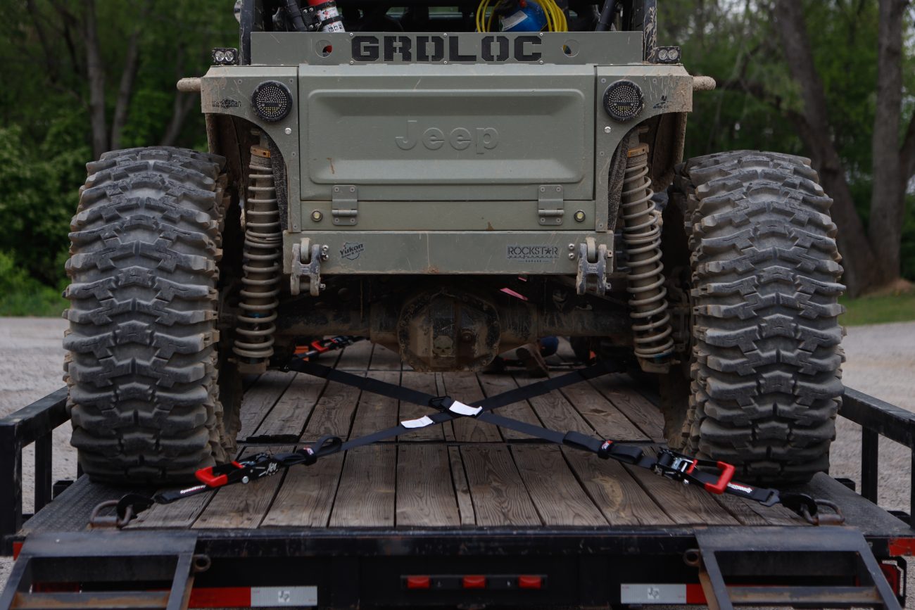 jeep secured to trailer with off-road tie-downs